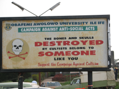 A photograph of a sign at Obafemi Awolowo University Ile Ife which reads Campaign Against Anti-Social Acts/The bonus and skulls destroyed by cultists belong to someone like you/Support the campaign against cultism