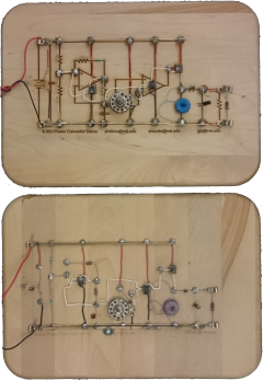A pair of cutting boards for bread, with a circuit schematic laser-etched onto them, and an actual circuit soldered on top