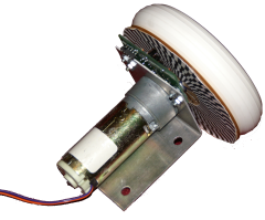 Motor with an optical encoder attached. The optical encoder consists of a custom printed circuit board, a laser-cut acrylic wheel, and a laser printed piece of paper attached to the wheel