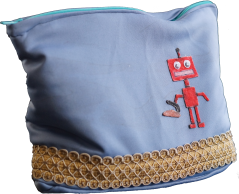 A bag for an iron, decorated with a frilly finish, and a CNC-cut robot (colored with permanent markers)
